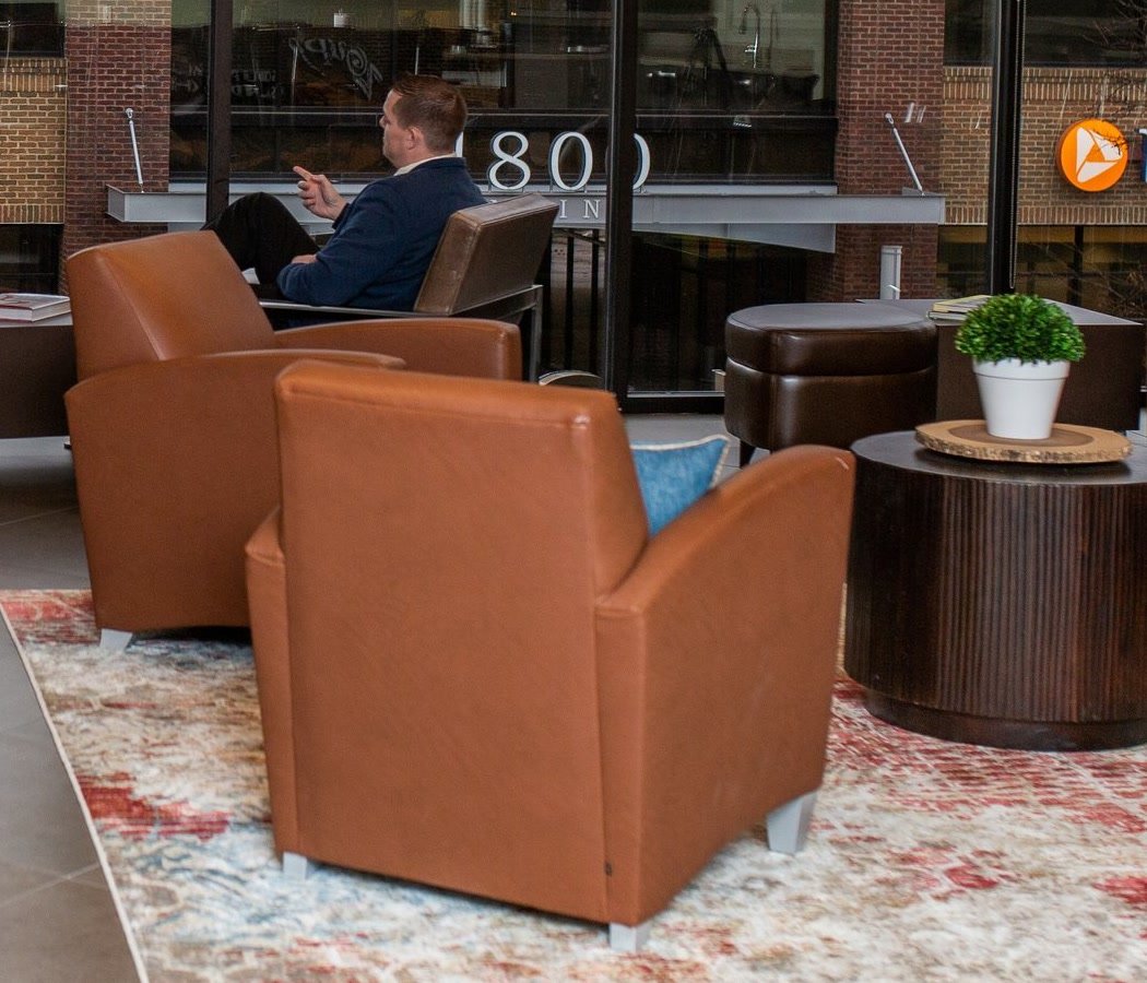 Leather lounge chairs in a warm office sitting area.